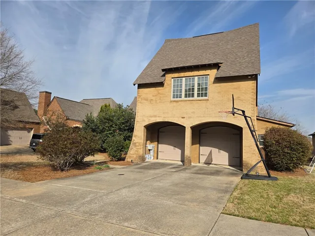 A well-maintained brick facade and arched garage doors enhance this property's curb appeal.