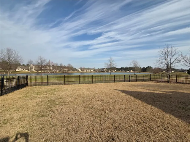 A tranquil backyard offers peaceful waterside living with neighborhood views.