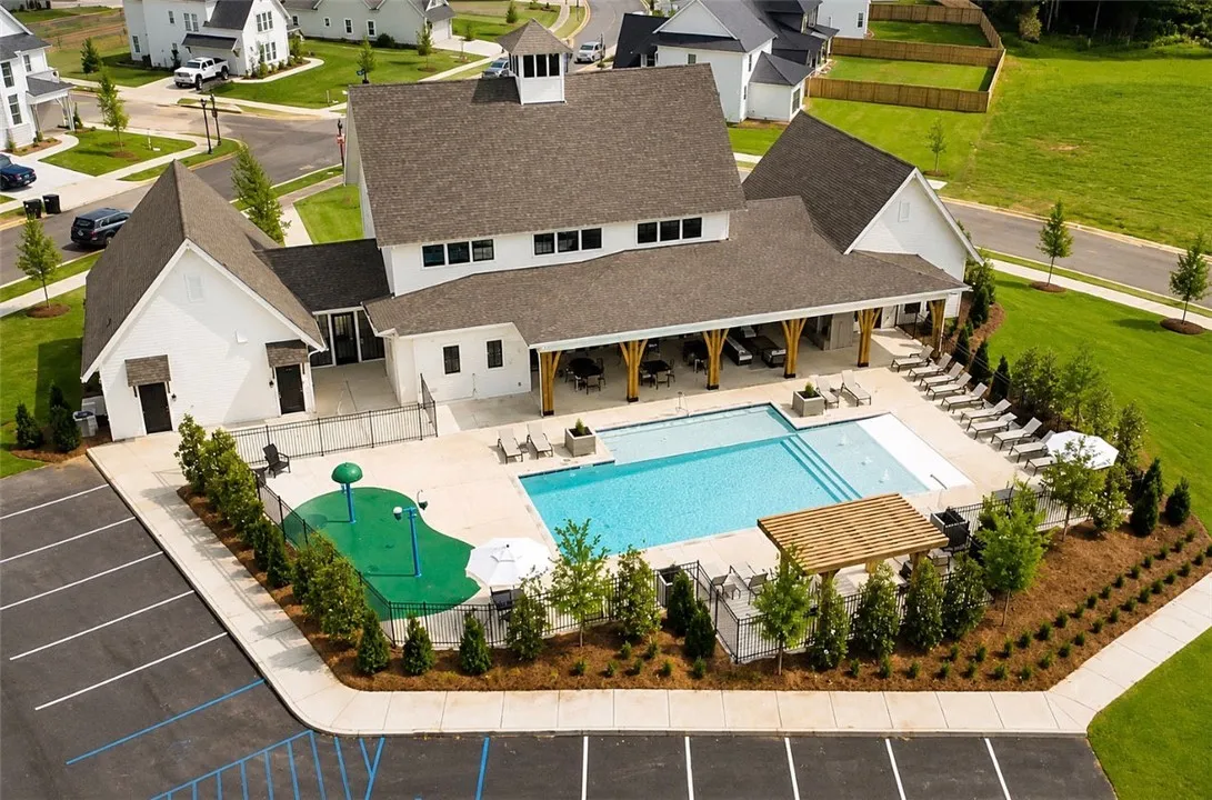 A community gathering place with a shimmering pool and covered patio, perfect for social events.