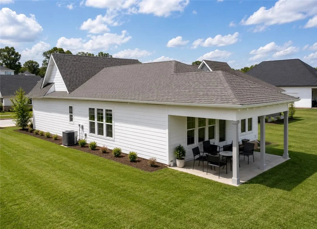 An inviting covered patio extends from this home, providing a perfect spot for outdoor enjoyment.