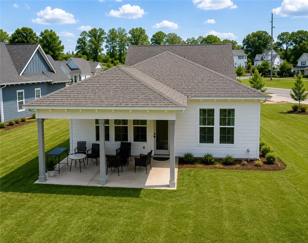 A private rear patio offers outdoor enjoyment, extending this charming home's living space.