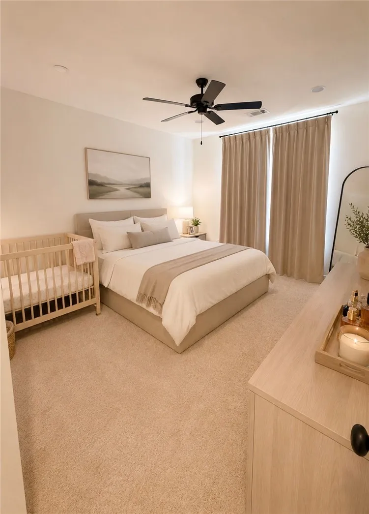 Relax in this well-appointed bedroom featuring soft carpeting and a ceiling fan for ultimate comfort.