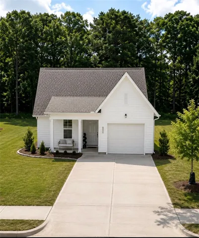 A classic white facade with a welcoming porch and pristine landscaping defines this charming residence.