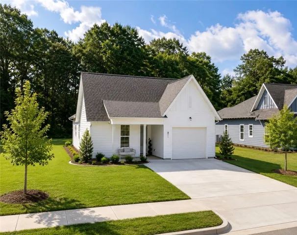 A well-maintained lawn and paved driveway welcome you to this charming single-story home.