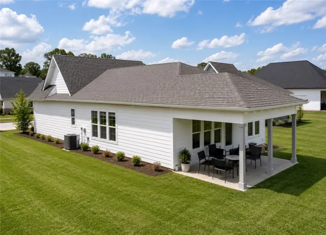 An inviting covered patio extends from this home, providing a perfect spot for outdoor enjoyment.