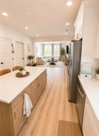 An open floorplan seamlessly connects the kitchen with a spacious living area, ideal for entertaining.