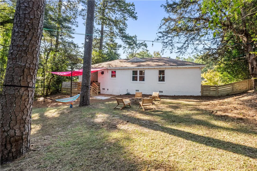 A private backyard oasis with a fire pit and deck, perfect for evening gatherings.