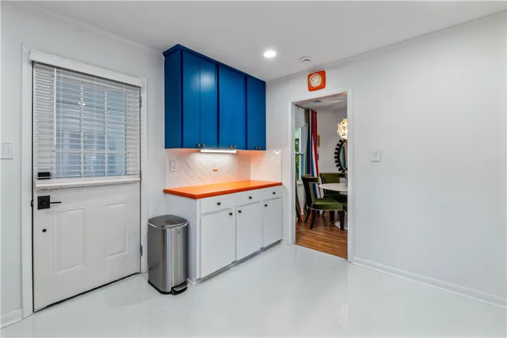 A well-appointed kitchen corner offers vibrant cabinetry and convenient countertop space.