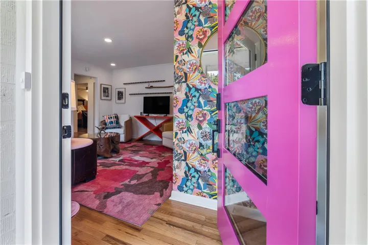 Enter into a vibrant living space featuring rich hardwood flooring and a stylish, open-concept design.