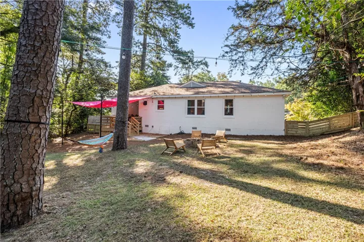 A private backyard oasis with a fire pit and deck, perfect for evening gatherings.