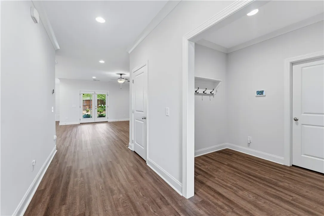 Rich hardwood-style flooring extends through this welcoming entry hall into bright living spaces.