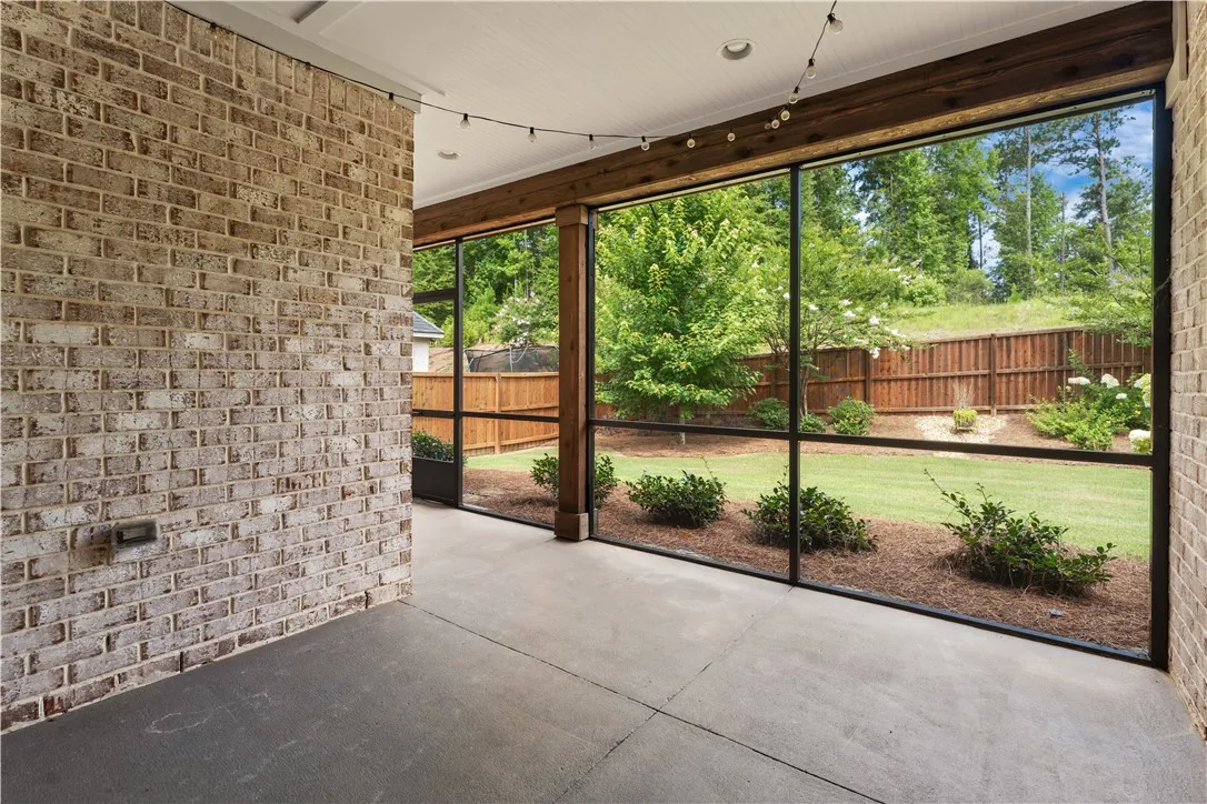 A screened porch opens to a private yard, offering tranquil outdoor living.