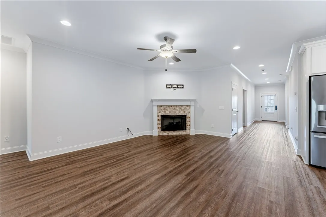 A welcoming living area boasts rich hardwood-style flooring and a charming tiled fireplace focal point.
