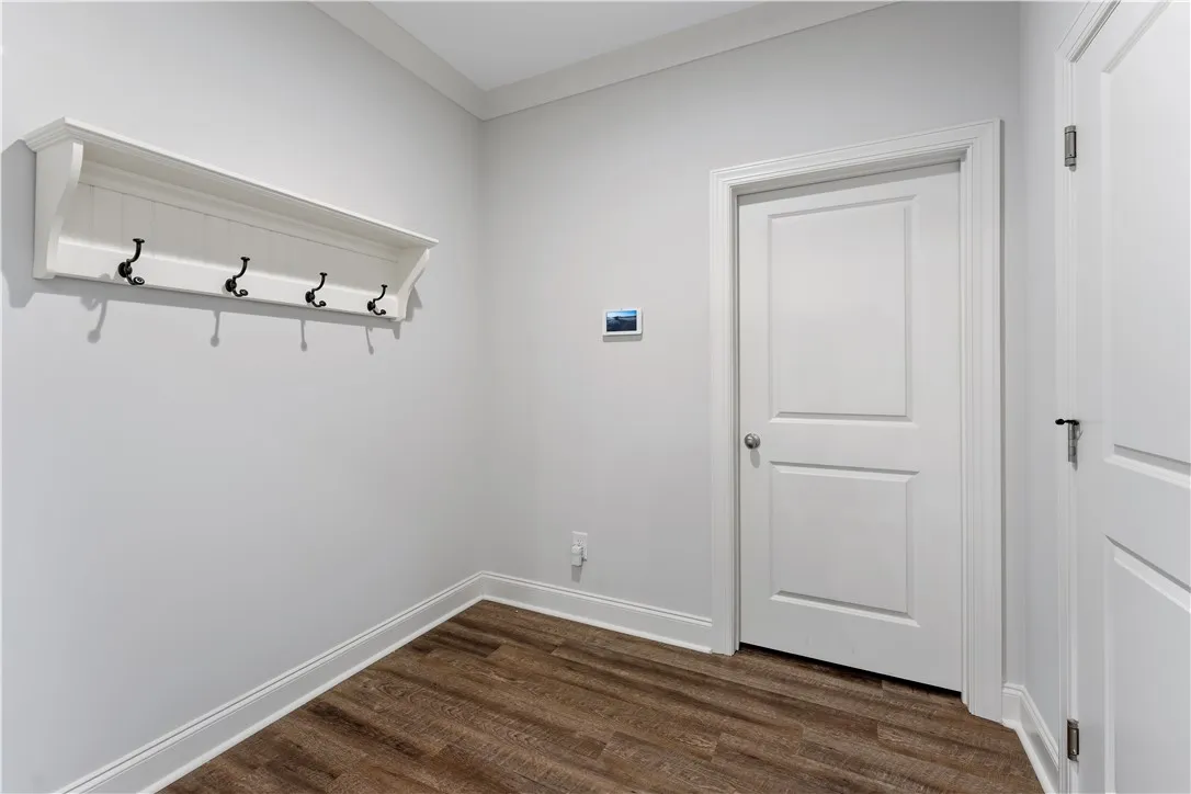 Clean lines and a coat rack offer a practical and welcoming entrance.