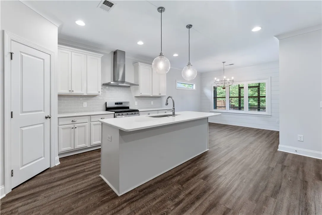 A well-lit kitchen with sleek stainless steel appliances and an inviting central island.