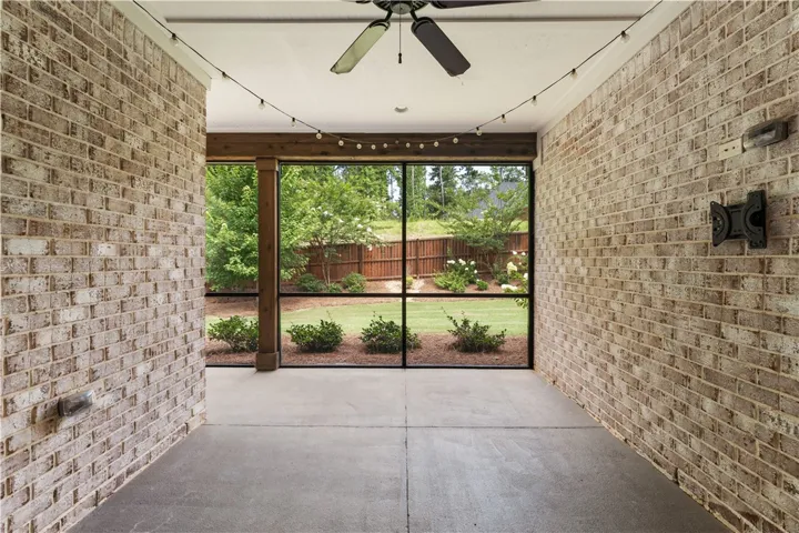 A private, screened patio offers a tranquil backyard outlook.