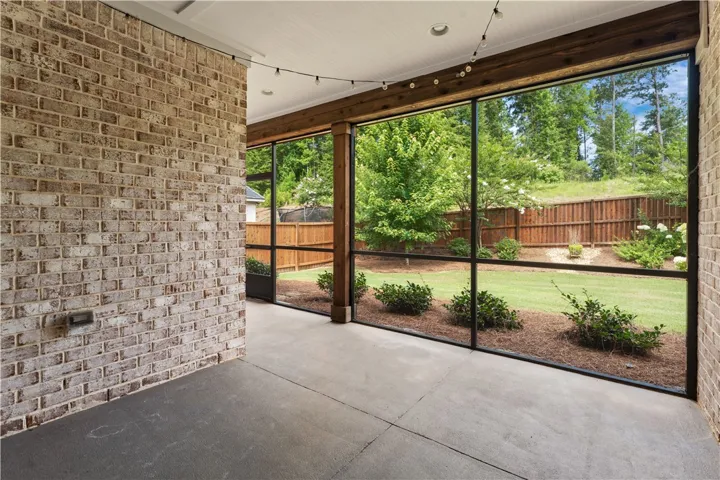 A screened porch opens to a private yard, offering tranquil outdoor living.