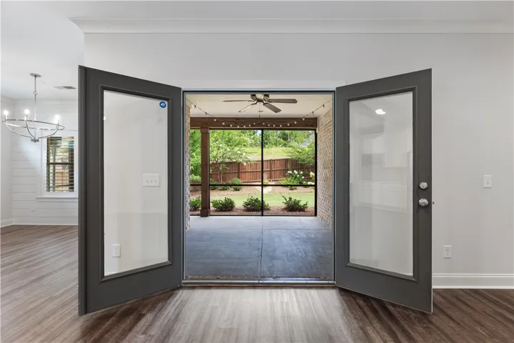 French doors open to a welcoming screened porch and a private backyard haven.
