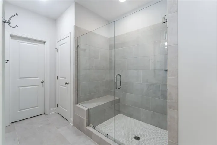 A well-appointed shower space showcases a tiled bench and glass enclosure, creating a streamlined bathing experience.