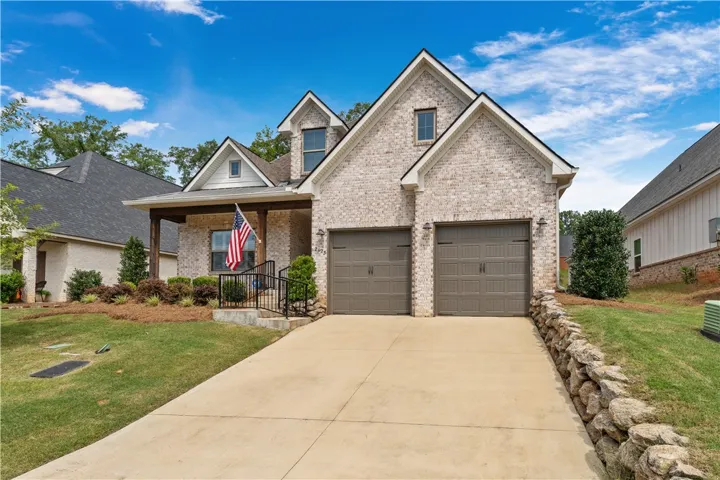 A classic brick exterior offers enduring curb appeal and a welcoming covered porch.