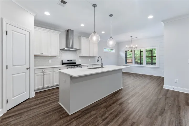 A well-lit kitchen with sleek stainless steel appliances and an inviting central island.