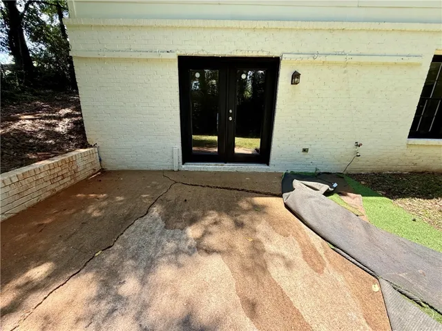 A private patio with brick construction and a direct backyard exit.