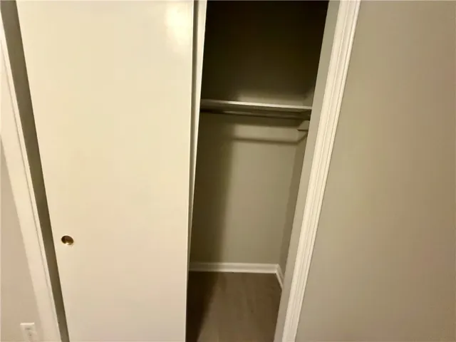 Functional closet featuring a single rod and shelving for organized storage solutions.