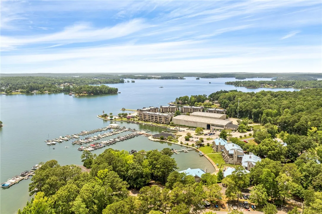Boasting waterfront living, this property includes a marina, inviting pool, and tranquil lake views.