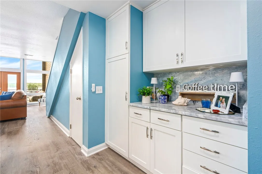 Custom cabinetry and durable flooring create a functional space with a charming dry bar.