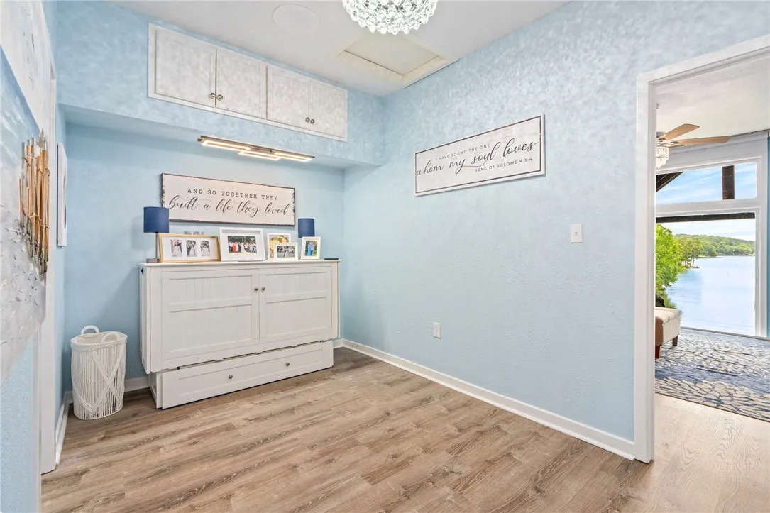 Naturally illuminated, this versatile room features practical built-in storage and durable wood flooring.