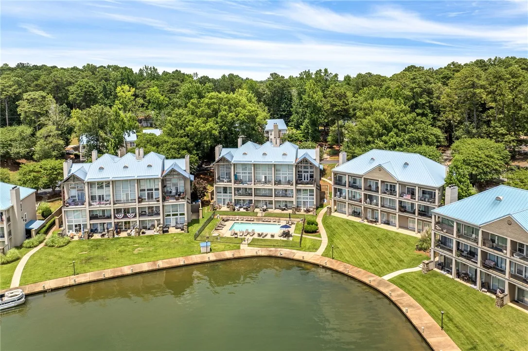 Lakeside condominiums with private balconies overlook the pool and verdant grounds.