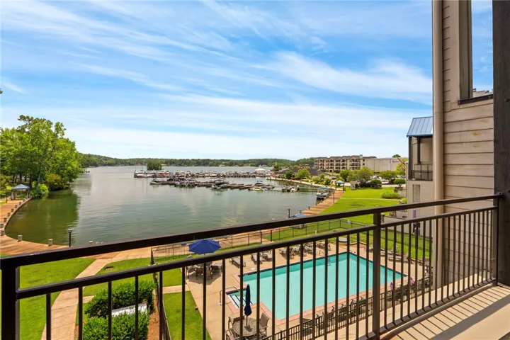 Uninterrupted lake vistas and a refreshing community pool await from this charming waterfront balcony.