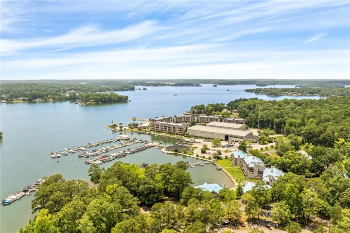 Boasting waterfront living, this property includes a marina, inviting pool, and tranquil lake views.