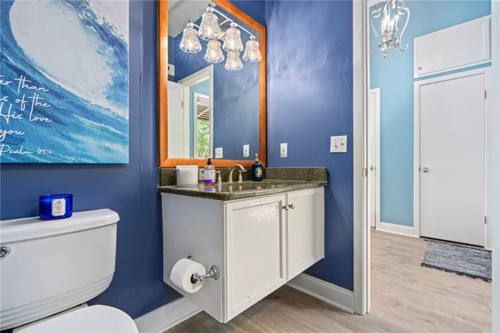 A well-appointed bathroom features a floating vanity with a polished counter and a complementary mirror.