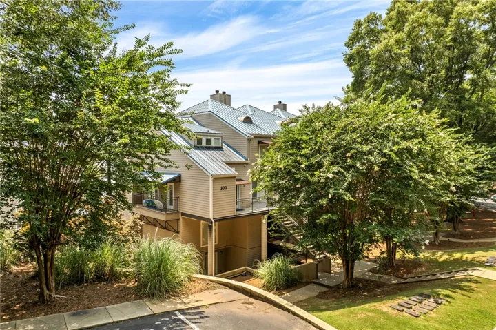 Multi-level townhouse with private balconies and lush landscaping for a serene residential experience.