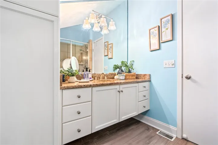 A well-lit bathroom features a spacious vanity with ample counter space and cabinet storage.