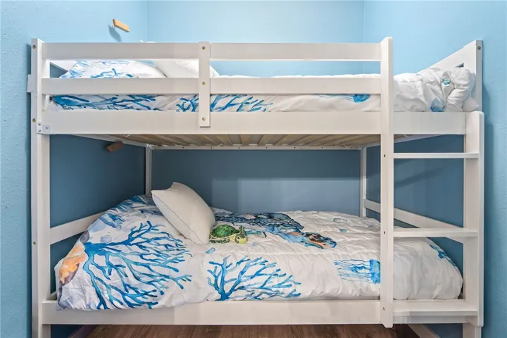 A spacious bedroom offers comfortable bunk beds, perfect for accommodating multiple guests.