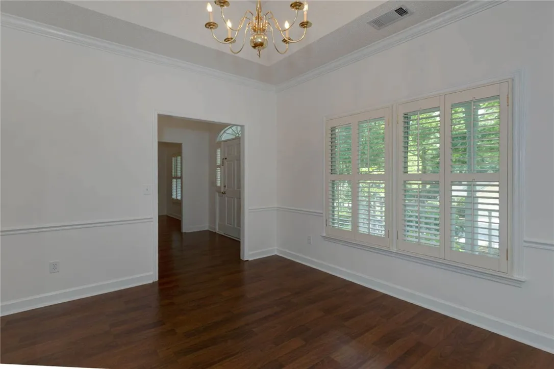 Hardwood floors and crisp wainscoting define this inviting dining area.