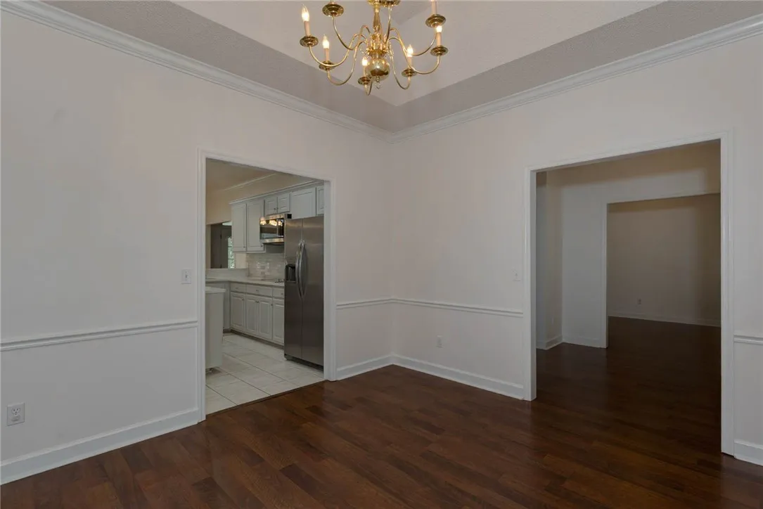 Warm hardwood flooring and crown molding define this versatile dining area.