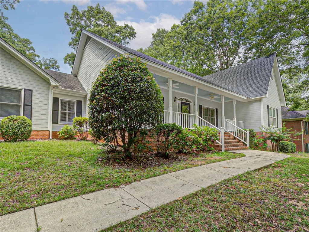 A graceful front porch extends a warm welcome, enhancing the home's inviting curb appeal.