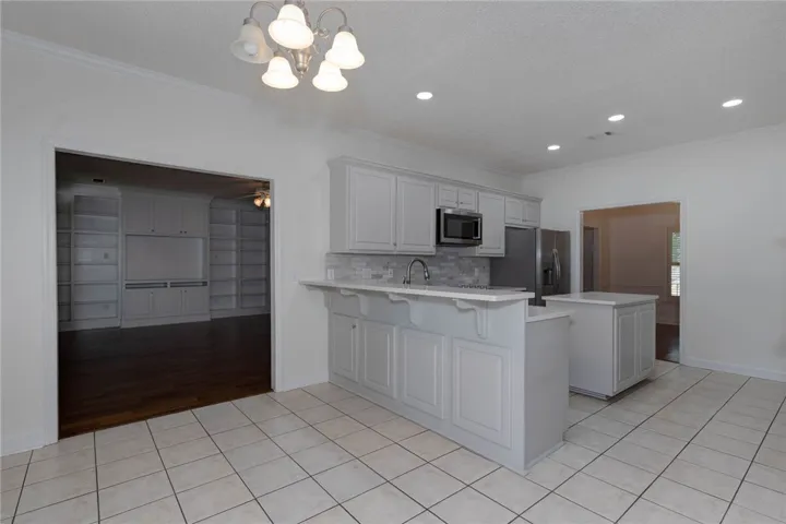A well-appointed kitchen featuring a functional island, ample counter space, and integrated appliances.