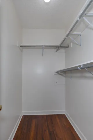 Streamlined storage solutions elevate this walk-in closet's functionality with ample shelving and hanging space.