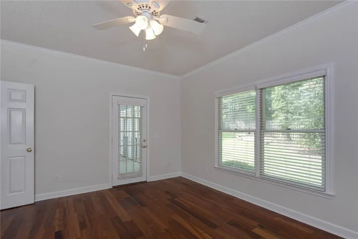 Rich hardwood floors complement an abundance of natural light in this inviting room.