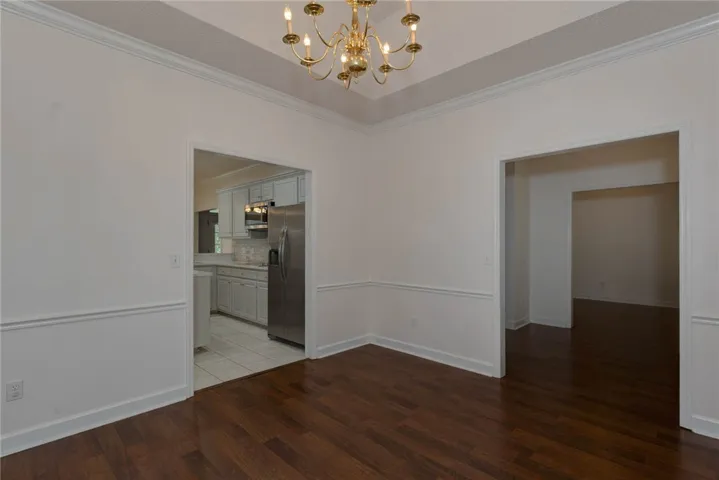 Warm hardwood flooring and crown molding define this versatile dining area.