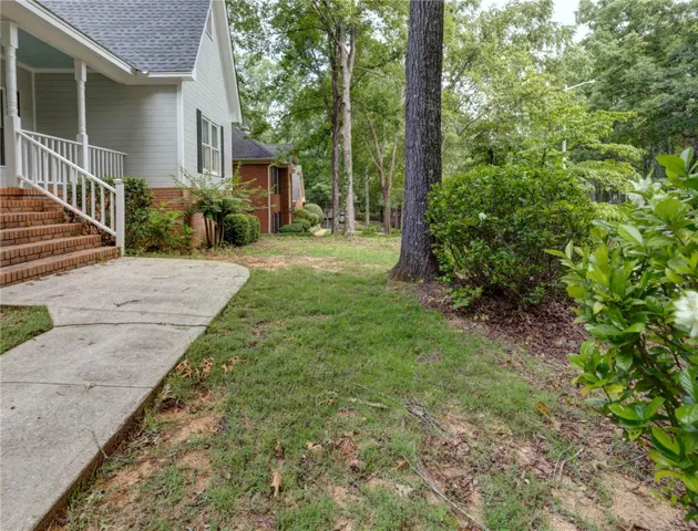 A classic facade with a welcoming porch and mature landscaping awaits.