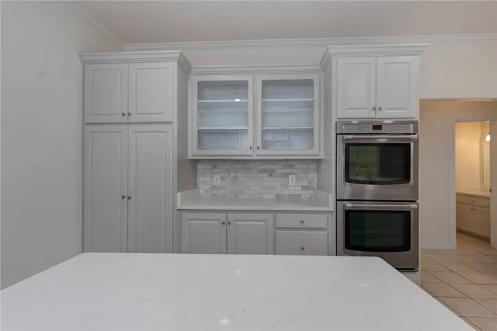 Culinary delights await in this bright kitchen with premium built-in double ovens and ample counter space.