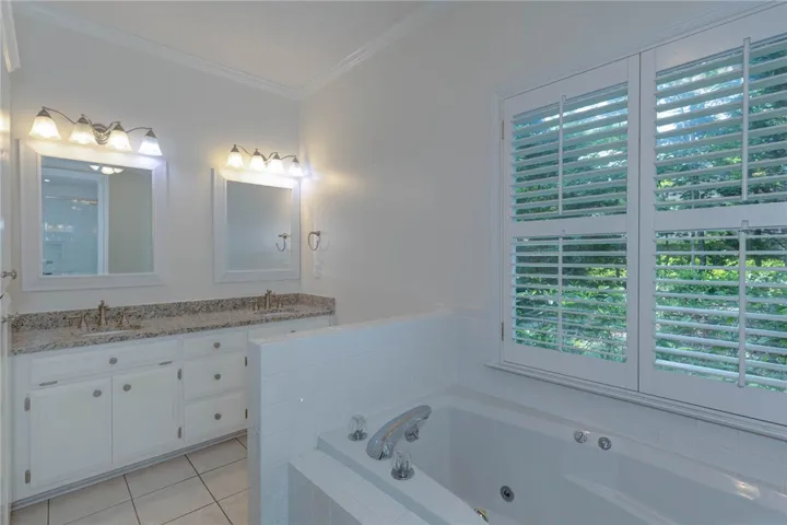 Double vanities and a deep soaking tub create a luxurious primary bathroom retreat.