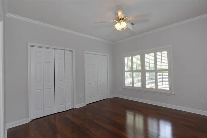 Rich hardwood flooring and window shutters create a comfortable and private retreat.