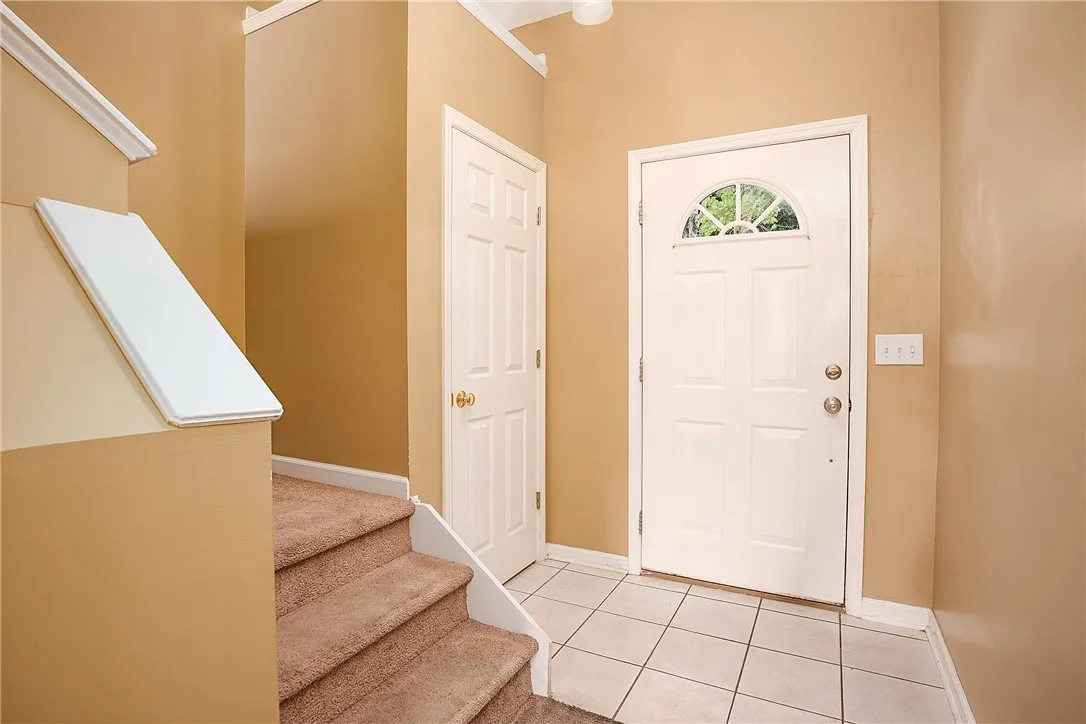Enter into a welcoming foyer with stairs leading to the next level.