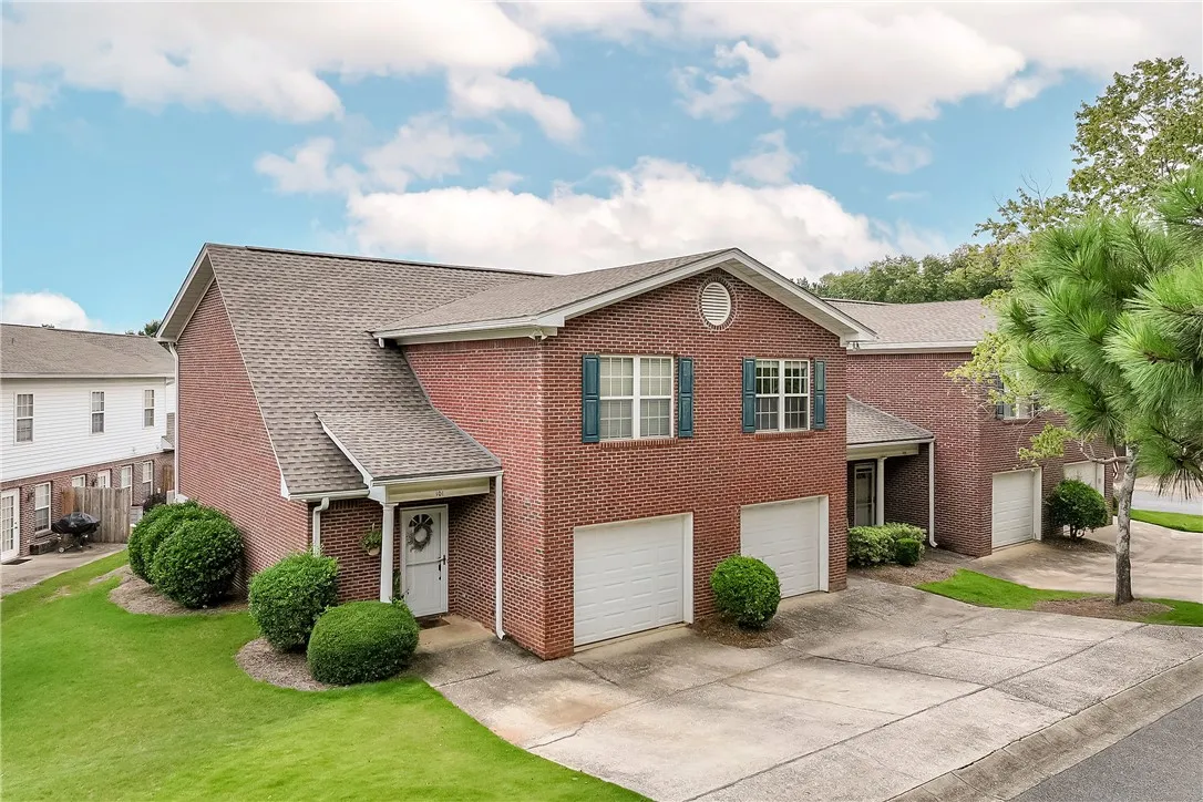 A classic brick exterior with well-maintained landscaping offers inviting curb appeal.